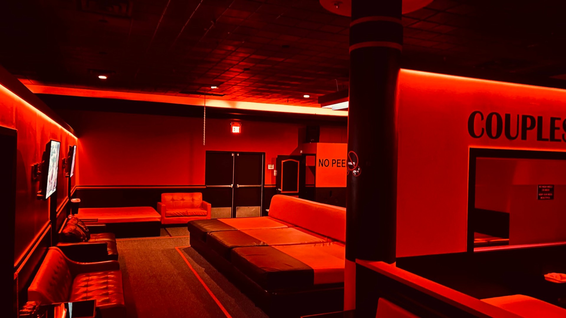 Couples lounge with crimson ambient lighting